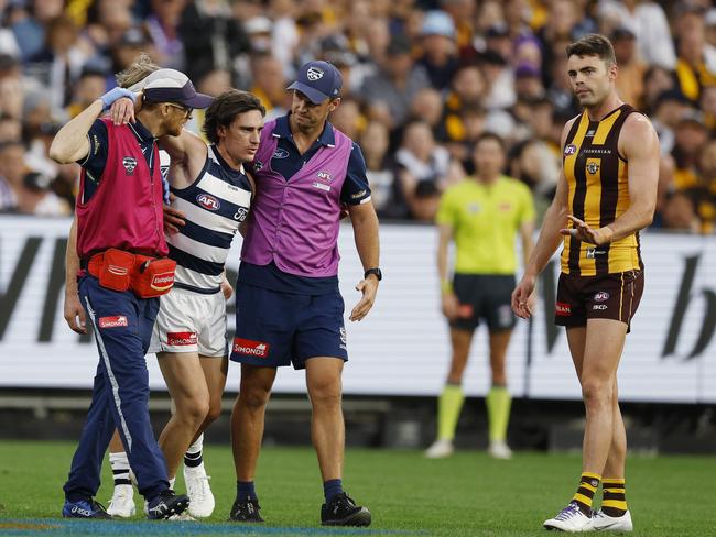 NCA. MELBOURNE, AUSTRALIA. April 19th, 2025 . AFL Round 6 .  Geelong vs Hawthorn at the MCG.  Gryan Miers of the Cats  is helped from the ground by medicos as Conor Nash of the Hawks apologises after cleaning him up during the 3rd qtr.       .   Picture: Michael Klein