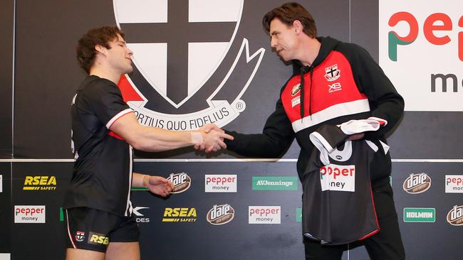 Nathan Freeman is presented with his debut jumper by Justin Koschitzke.