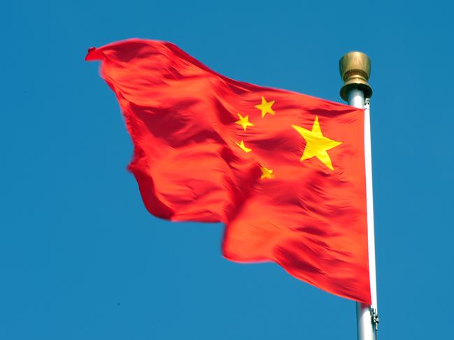 The Chinese flag flutters in Tiananmen Square, after the sacking of politician Bo Xilai from the countries powerful Politburo, in Beijing on April 11, 2012. Once a rising political star known for busting gangs and reviving Maoist ideals, China's Bo Xilai has suffered a dramatic fall from grace that now sees him linked to a suspected murder. The 62-year-old was once a leading contender to enter the top rungs of power, but in a stunning reversal of fortune he was sacked as head of Chongqing city and late Tuesday suspended from the Communist Party's powerful Politburo. AFP PHOTO/Mark RALSTON