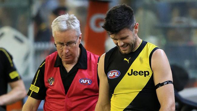 Trent Cotchin in pain on the bench. Picture: Mark Stewart