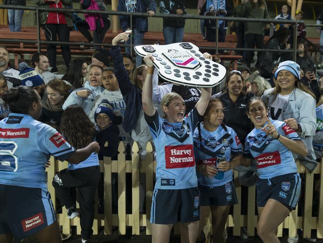 Maddison Studdon of the Blues holds the shield aloft