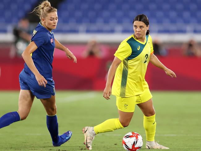 YOKOHAMA, JAPAN - AUGUST 02: Sam Kerr #2 of Team Australia runs with the ball whilst under pressure from Lina Hurtig #8 of Team Sweden during the Women's Semi-Final match between Australia and Sweden on day ten of the Tokyo 2020 Olympic Games at International Stadium Yokohama on August 2, 2021 in Yokohama, Japan. (Photo by David Ramos/Getty Images)