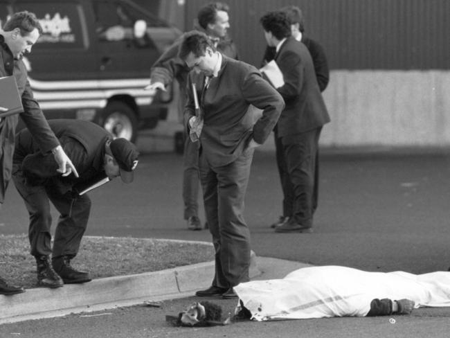 Norman Lee lies covered by a sheet, his rubber mask on the ground next to his body. Picture: Library NWN