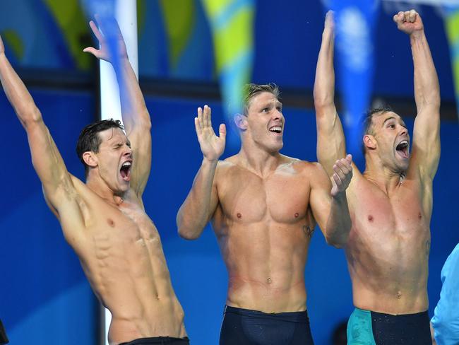 Mitch Larkin celebrates the 4x100 medley relay win with teammates Jake Packard and Grant Irvine. Picture: AAP Image/Darren England