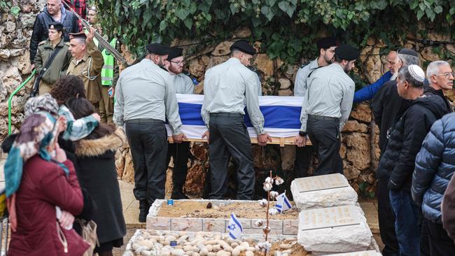 Friends and family members mourn as soldiers carry the coffin of late Major General Yonatan Malka during his funeral ceremony in the Mount Herzl cemetery in Jerusalem.