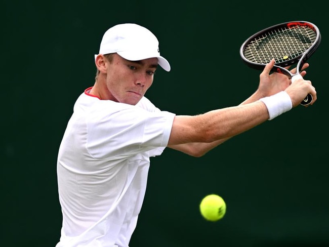 LONDON, ENGLAND – JULY 09: Hayden Jones of Australia plays a backhand against Manas Dhamne of India in the Boy's Singles first round match during day seven of The Championships Wimbledon 2023 at All England Lawn Tennis and Croquet Club on July 09, 2023 in London, England. (Photo by Mike Hewitt/Getty Images)