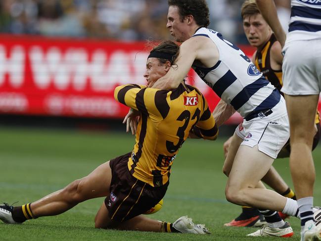 MELBOURNE , AUSTRALIA. April 1, 2024.  AFL Round 3.  Hawthorn vs Geelong at the MCG.   Jack Ginnivan of the Hawks gets takin high by Max Holmes but no free kick during the 3rd qtr.    . Pic: Michael Klein