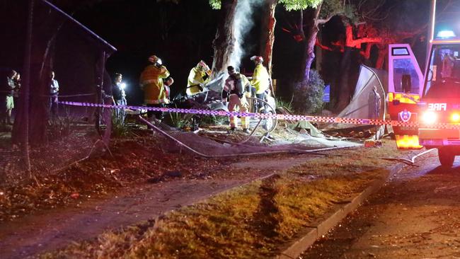 The car was destroyed from the impact family and friends arrived at the scene, pushing past police to get to the man. Picture Bill Hearne