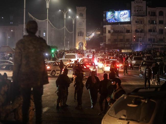 Residents take to the streets of Hama, to welcome anti-government fighters after they took control of Syria's west-central city. Picture: AFP