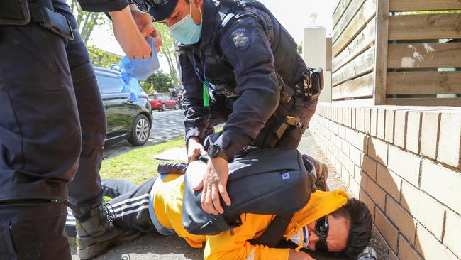 Police chase an anti-lockdown protester. Picture: Alex Coppel