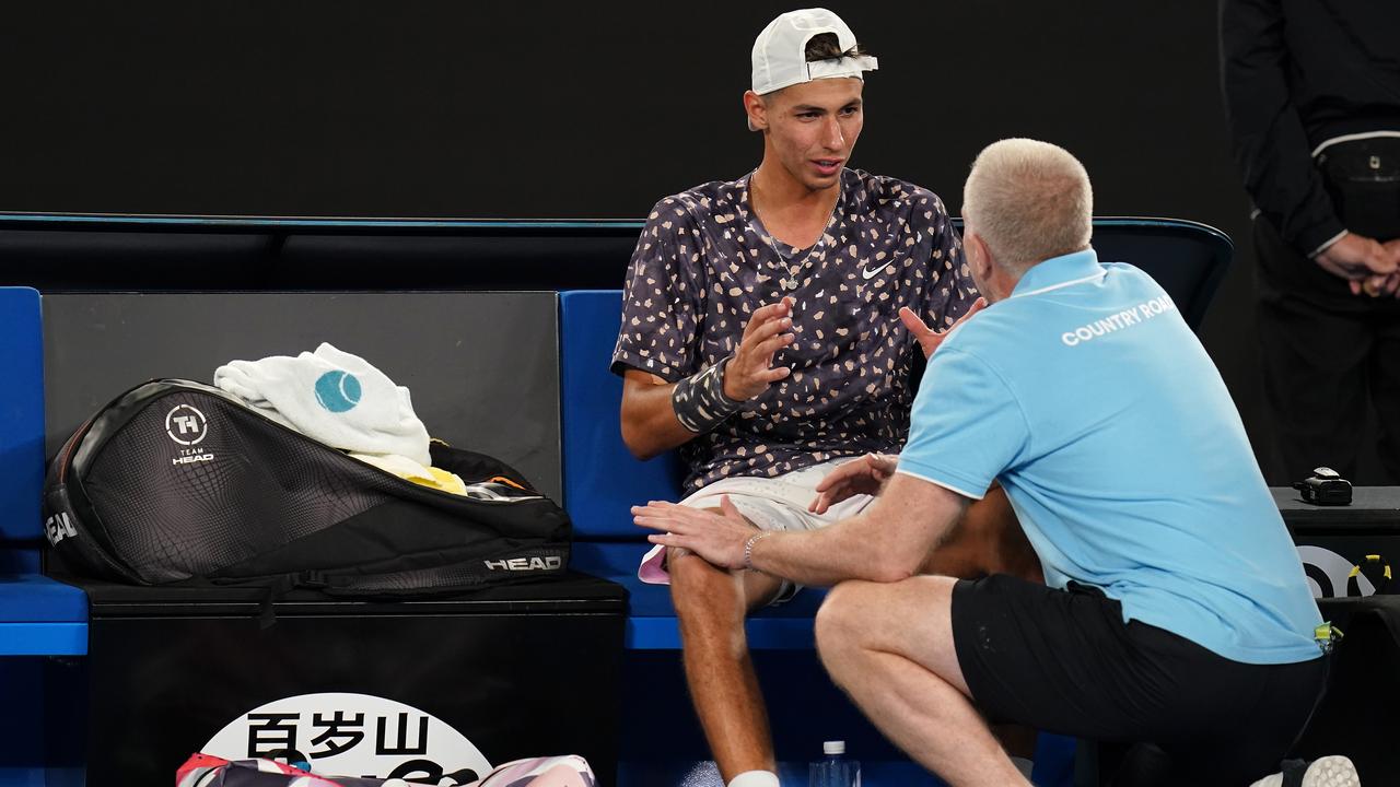 Alexei Popyrin receives medical treatment during his third round match against Daniil Medvedev.