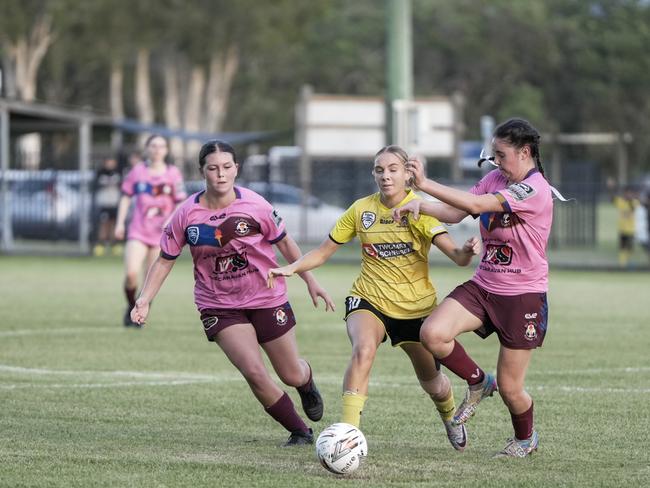 Taryn Knight from Edge Hill Tigers trying to get through two MA Olympic defenders. Picture: Nuno Avendano