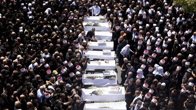 Mourners attend a funeral held for 10 of the victims of the rocket attack in Majdal Shams, Golan Heights. Picture: Getty Images