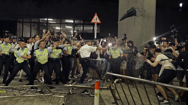 Hong Kong police turn pepper spray on protesters trying to ‘storm’ the Legislative Council early yesterday. Picture: AP.