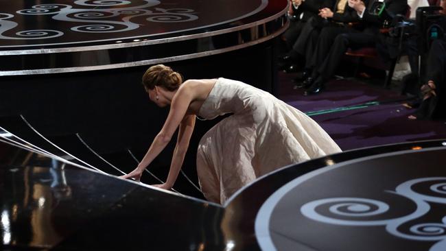 Jennifer Lawrence falls as she approaches the stage to accept her award for best actress for "Silver Linings Playbook," at the Oscars at the Dolby Theatre on Sunday Feb. 24, 2013, in Los Angeles. (Photo by Matt Sayles/Invision/AP)