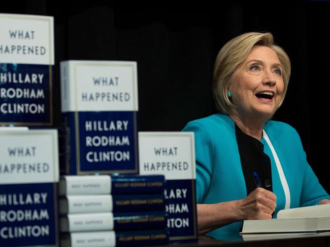 Former US secretary of state Hillary Clinton signs copies of her new book What Happened in New York City. Picture: Drew Angerer/Getty Images/AFP