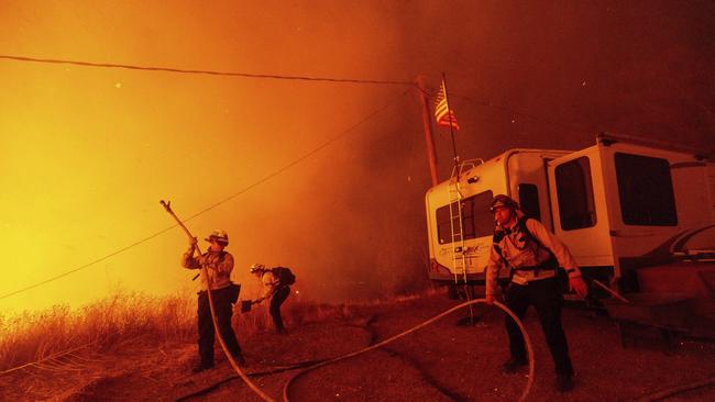 Firefighters in Castaic, California on January 22. The real cost of inefficient climate policy is that it distracts resources and attention from other priorities, writes the author. Picture: AP