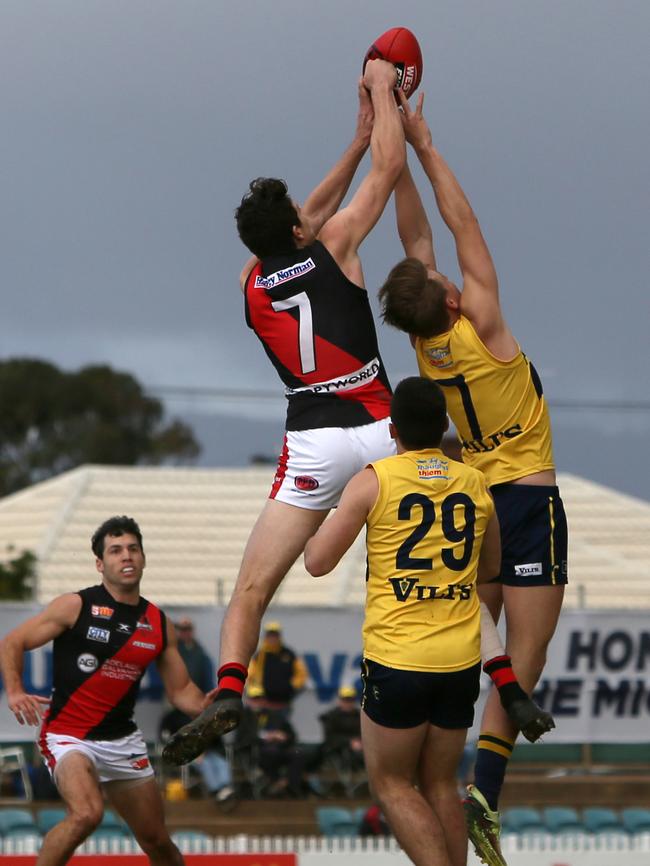 : AFL draft prospect Chris Burgess leaps over Eagle Nick Hayes. Picture: Emma Brasier/AAP