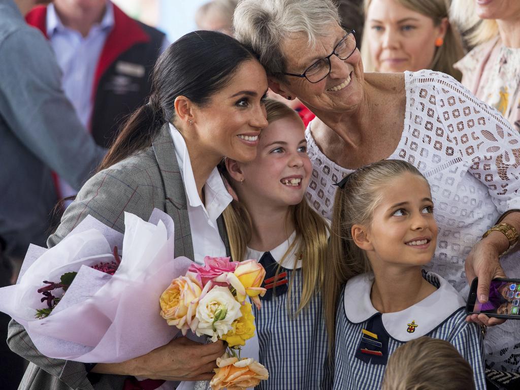 Meghan, Duchess of Sussex poses for a photo with members of the public at the naming and unveiling of a new Royal Flying Doctor Service aircraft at Dubbo City Regional Airport. Picture: Dominic Lipinski/AP.