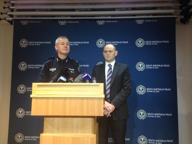 Assistant Commissioner Paul Dickson and DECD deputy chief executive David Waterford talk to the media.