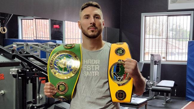 Kris Terzievski shows off his belts at Mace Fitness. Picture: Ben Higgins