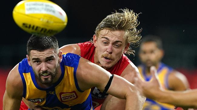 Hugh Greenwood lays a strong tackle on Jarrod Brander of the Eagles. Picture: AAP/Dave Hunt