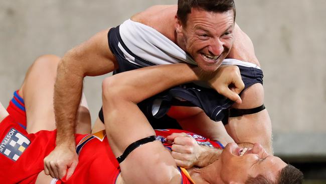 Brent Harvey and Glen Jakovich come to blows — and have a laugh — during Friday night’s EJ Whitten Legends Game. Pic: Getty Images