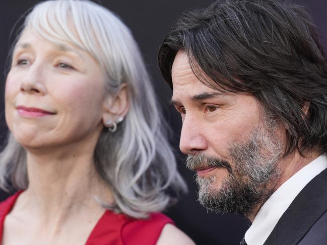Alexandra Grant, left, and Keanu Reeves arrive at the premiere of 
