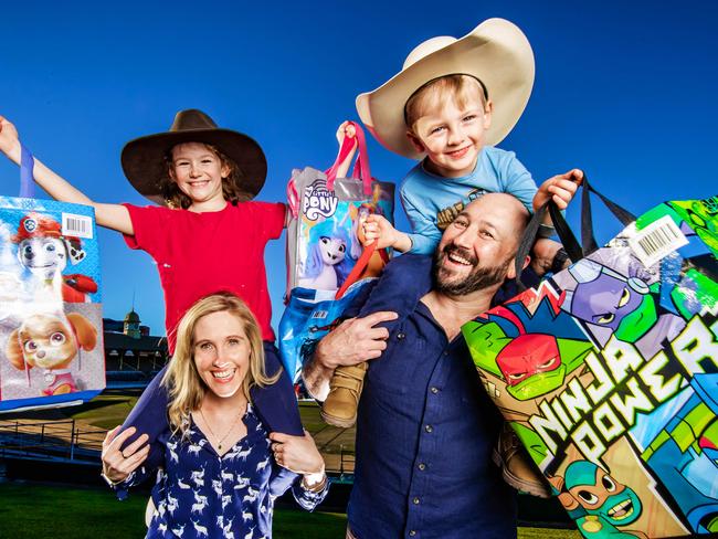 Ekka Tickets 2023.Tina and Tony White with their kids Lincoln, 4 and Felicity, 8 with showbags ahead of the Ekka.Picture: Nigel Hallett