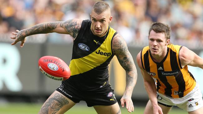 Dustin Martin pounces on a loose ball ahead of Blake Hardwick. Picture: Michael Klein