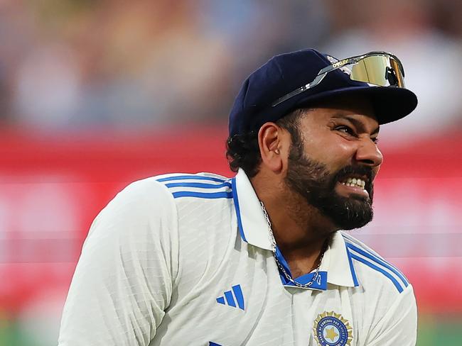 ADELAIDE, AUSTRALIA - DECEMBER 06: Rohit Sharma of India clutches his wrist after being struck by the ball during day one of the Men's Test Match series between Australia and India at Adelaide Oval on December 06, 2024 in Adelaide, Australia. (Photo by Robert Cianflone/Getty Images)