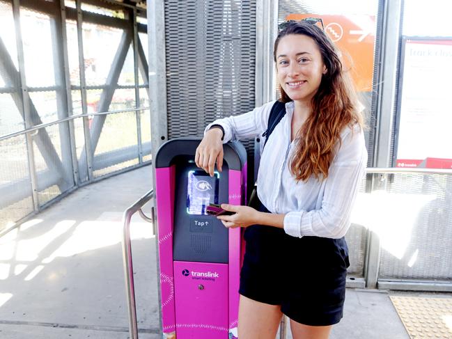 Commuter Hayley Micah tapping off at the machine with her Phone/Visa Banking. Photo Steve Pohlner