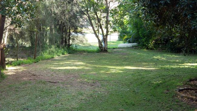 The unfenced waterfront land next to properties near Bill Mitchell Park.