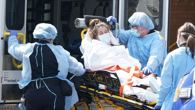 A woman arrives at a Brooklyn hospital in New York on Sunday Picture: AFP