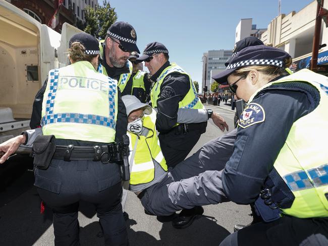 Police arrest an Extinction Rebellion Tasmania protester. Picture: Zak Simmonds