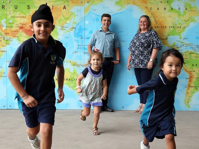 22/03/2019. St Luke's Secondary College students (L-R) Agamdeep Chhatwalis (9), Gracie Smith (3), Penelope Buere (5), Riley Bettiol (13) and Assistant Principle- Head of School of Foundations, Michelle O'Leary attend the prototype for future schools being developed by the Catholic education system. The school offers preschool through to Year 12 (and in some cases post-school education options) and will cost around $160 million once fully completed. Victoria and Queensland are looking closely at the model. Jane Dempster/The Australian.