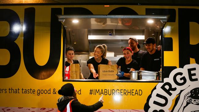 Tim Rofenstrauss working at the Burger Head Food Truck serves a happy customer at Bella Vista in Sydney. Picture: Gaye Gerard/ Sunday Telegraph