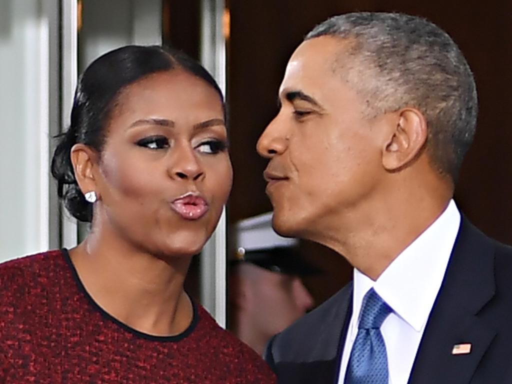 Former US President Barack Obama and First Lady Michelle Obama kiss as they prepare to greet President-elect Donald Trump and his wife Melania in 2017. Picture: AFP