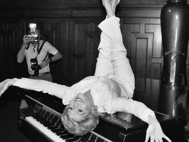 September 8, 1982. Actress Debbie Reynolds poses on a grand piano at a New York restaurant, as she promotes the revival of the hit musical “The Unsinkable Molly Brown.”. Picture: AP Photo/Marty Lederhandler