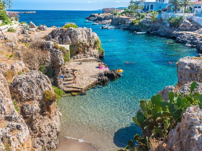 People swimming in a beach in Avlemonas village in the Kythera island in Greece.