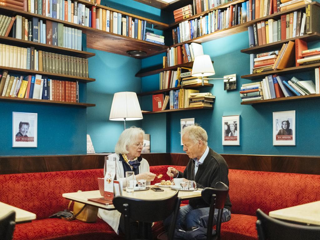 At a busy cafe in Vienna, a couple share an apple strudel. With pastel colours and shelves full of books, the scene seems timeless. Picture: Guido Caltabiano/Pink Lady® Food Photographer of the Year