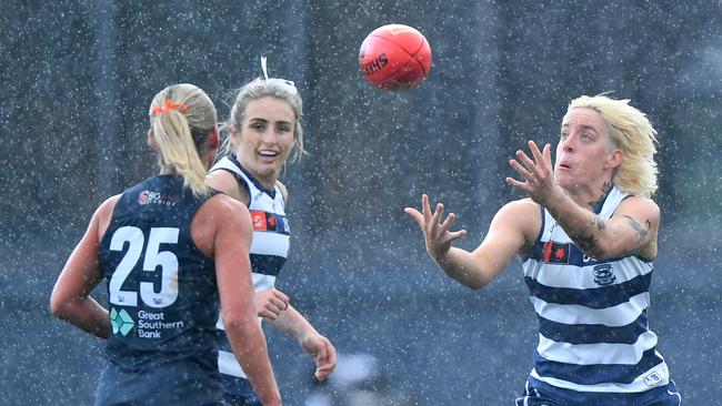 Geelong’s Gabbi Featherston attempts to mark as the rain tumbles down. Picture: Josh Chadwick/AFL Photos/via Getty Images.