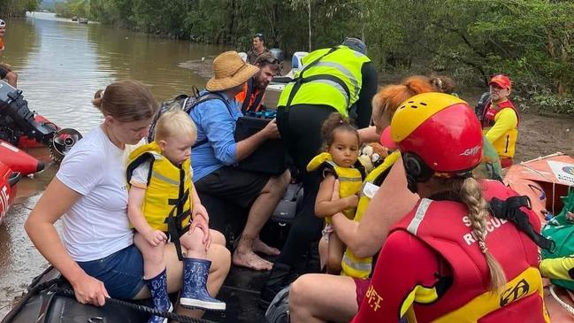 Penny Fenner and her two-year-old daughter Mahlia were rescued by surf life savers as rapidly rising flood water entered their HOlloways Beach home as the Barron River flooded on Sunday. Picture" Supplied.