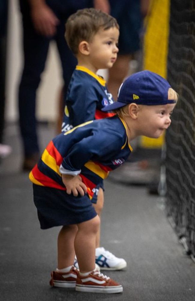 Hugo Walker and Sonny Sloane watch their dads in the changerooms after the Adelaide Crows win yesterday. Picture: Adelaide Football Club