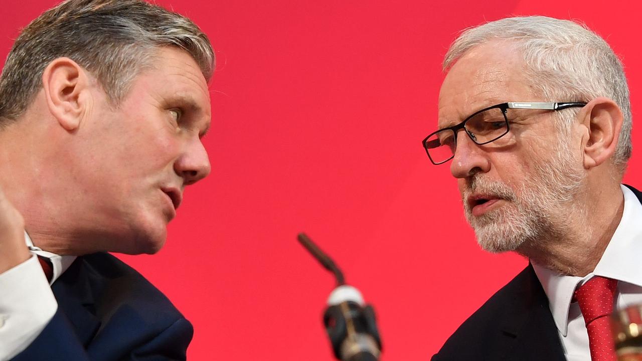 Then opposition Labour Party leader Jeremy Corbyn (R) speaks with Keir Starmer, the man who would replace him a year later. (Photo by Ben STANSALL / AFP)