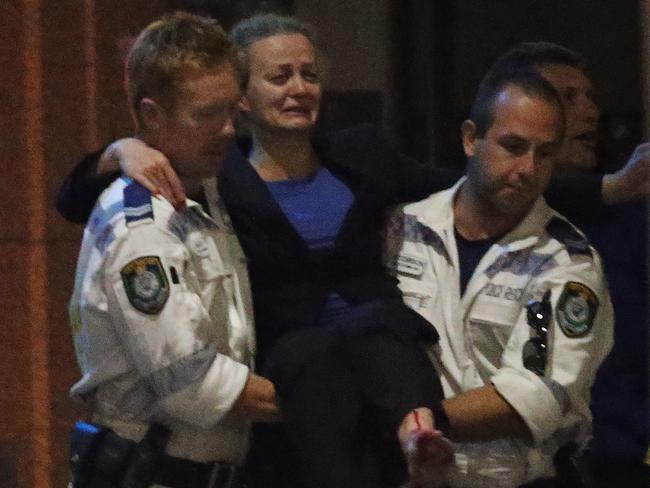 Marcia Mikhael is carried by police rescue after the Lindt cafe siege. Picture: AP Photo/Rob Griffith