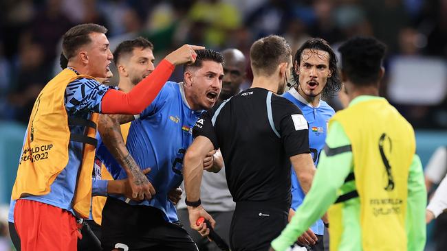 Uruguay players argue with referee Daniel Siebert after their match against Ghana. Picture: Getty Images