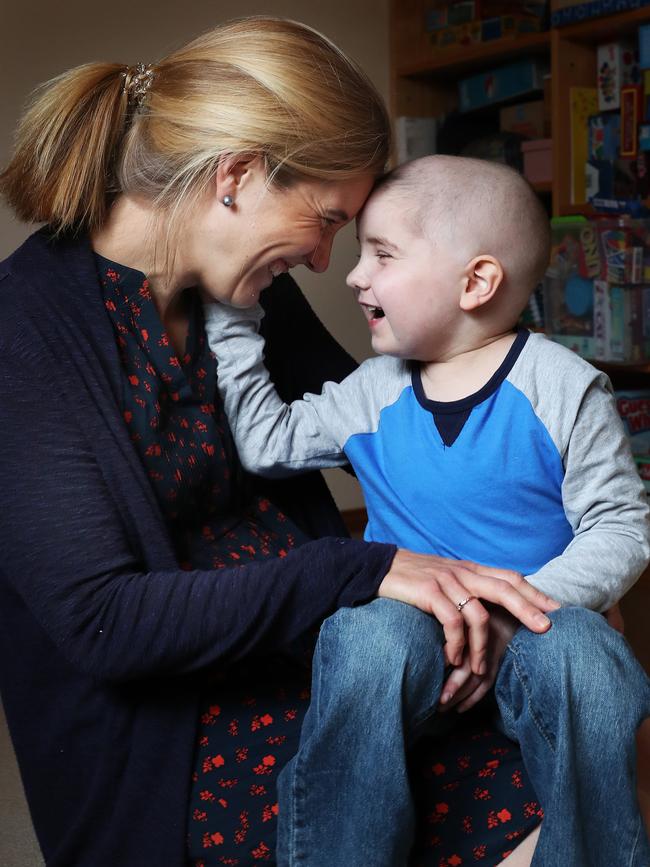 Ned with mum Emily Isham. Ned Isham is back home in Hobart after a long year of treatment both in Australia and the US. Ned is now cancer free and continuing his recovery at home with his family. Picture: NIKKI DAVIS-JONES