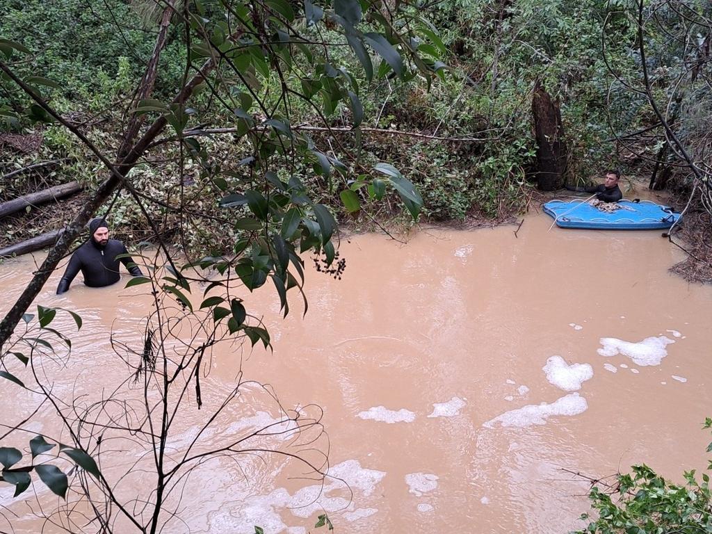 Police divers in Sandy Creek at Nanango searching for a vehicle after the body of a 47-year-old local was pulled from the water.