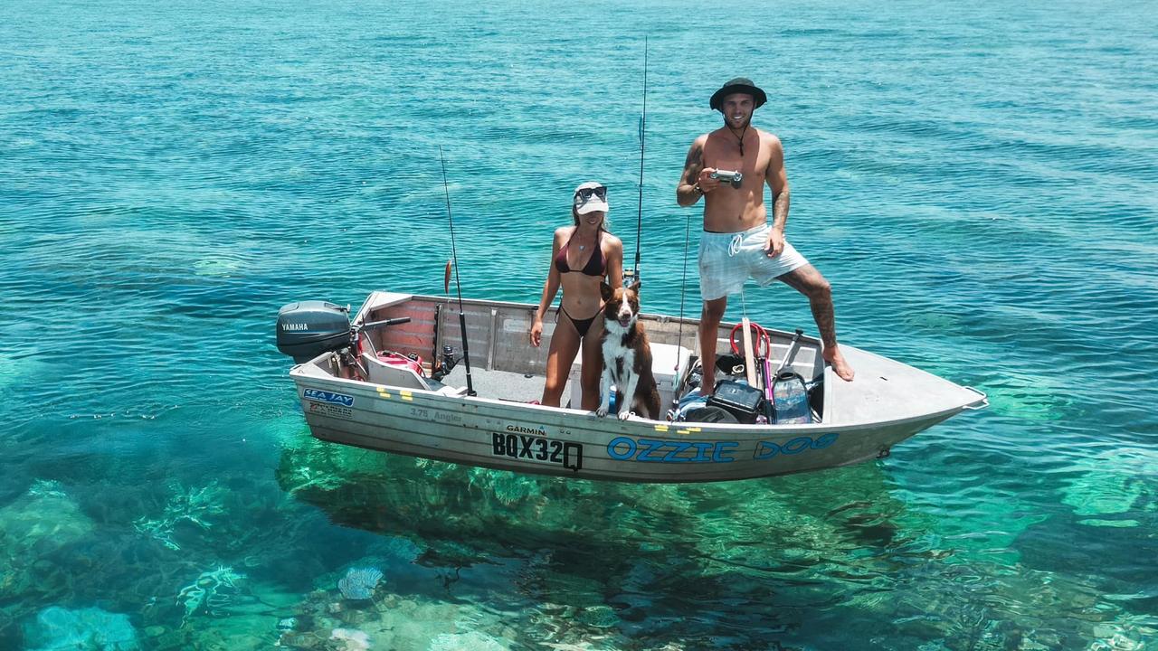 Reef Addicts Josh Matulis, partner Larissa Rogers and “fishing-obsessed” adventure dog Tyro on the Great Barrier Reef. Picture: Supplied